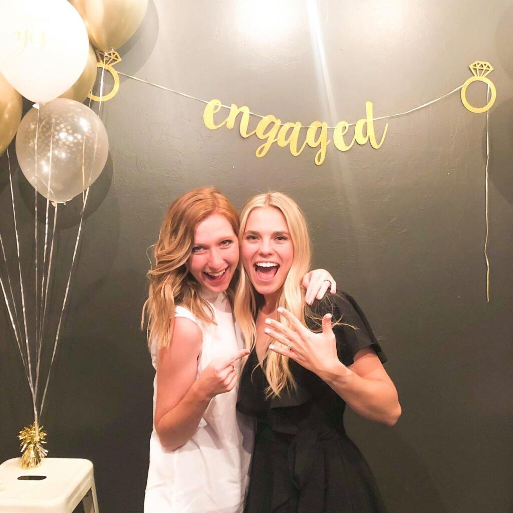 Hannah and Ashlyn at Hannnah's engagement party. They are standing together, smiling at the camera.